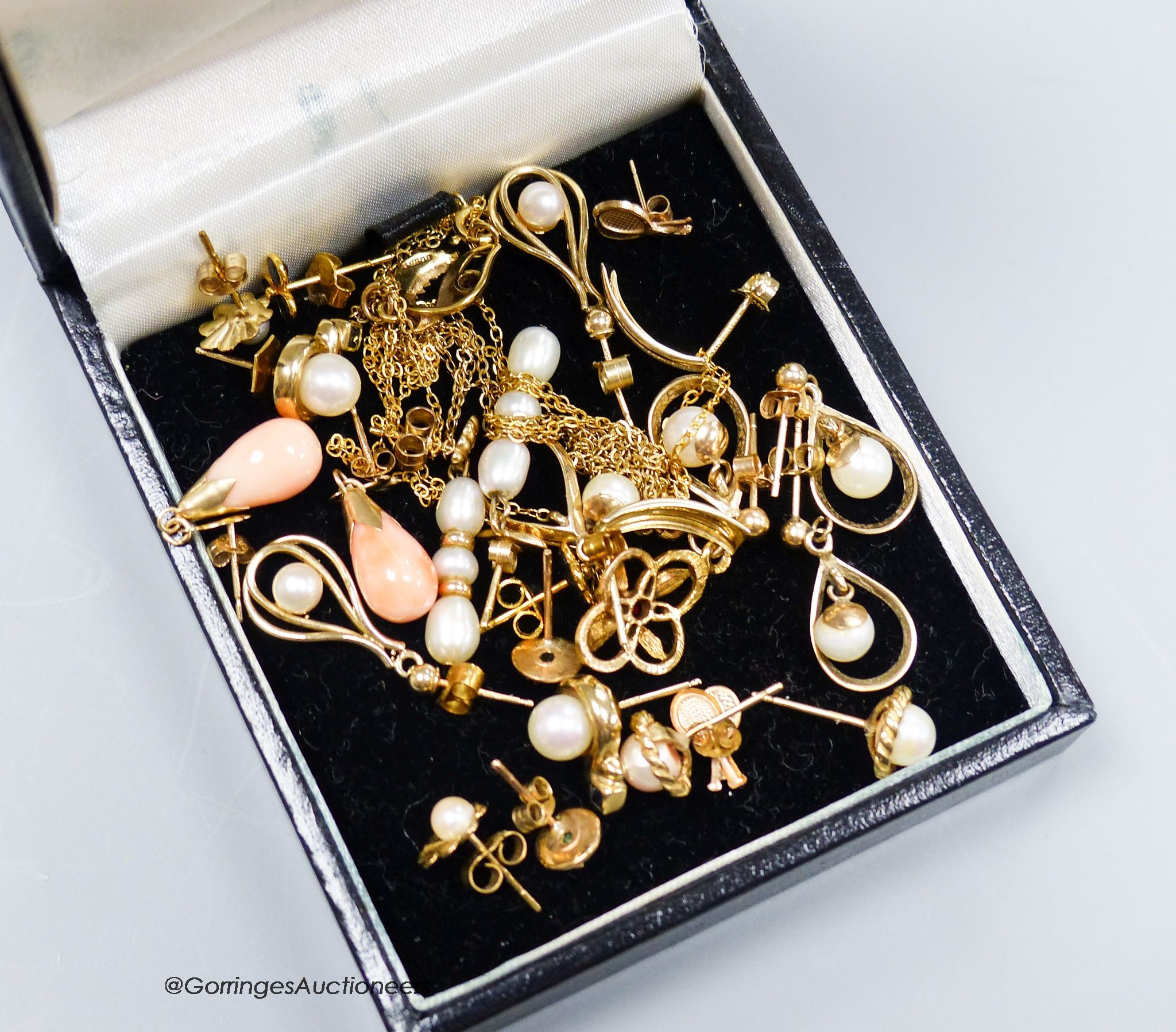 Twelve pairs of yellow metal earrings and two similar pendants, gross 19g.